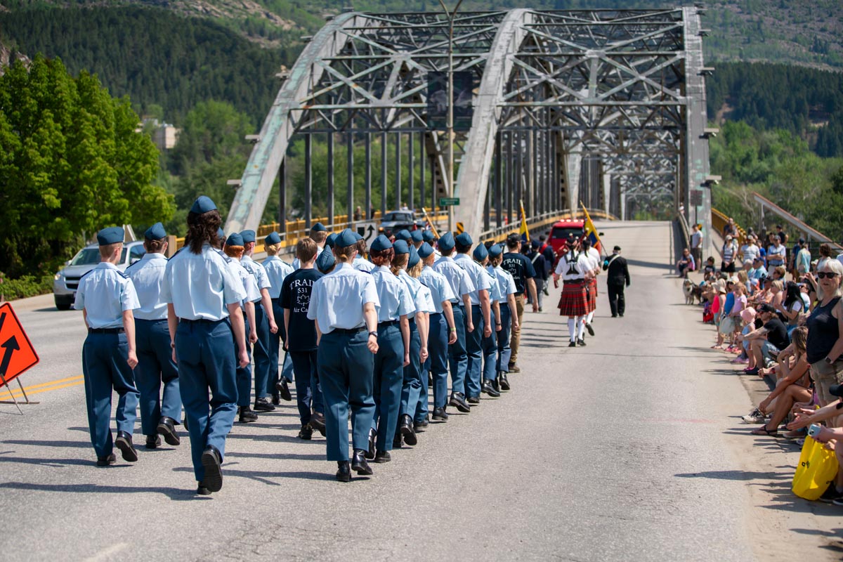 SCD Gallery_03 Group of uniformed cadets marching on a bridge during a parade with spectators seated along the roadside